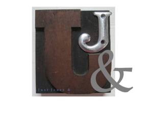 Logo shows a metallic J bolted onto a wooden carved J, with a grey ampersand in the foreground.